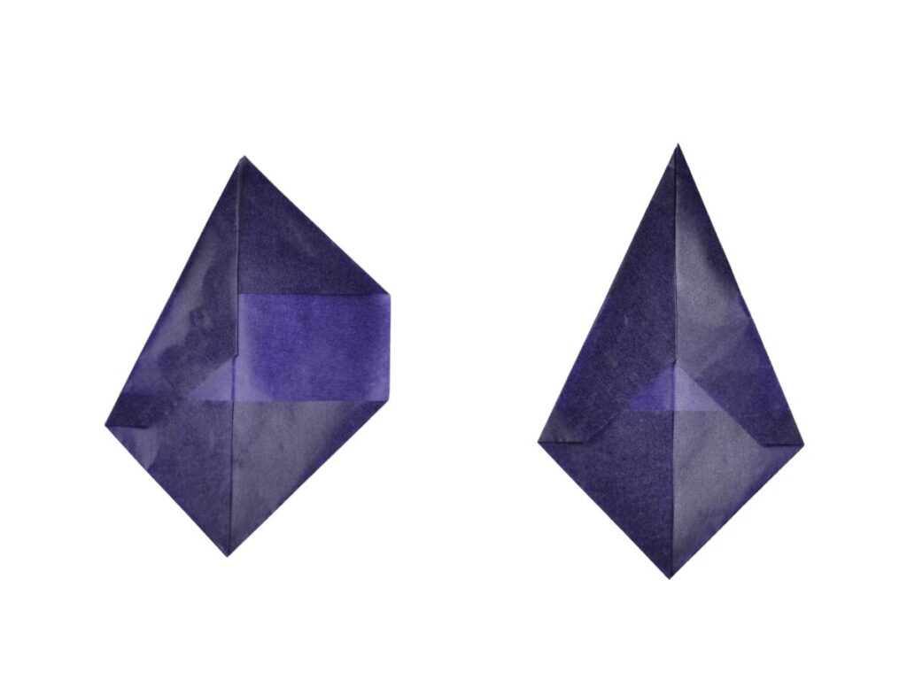 2 Pieces of kite paper folded to form a kite shape.