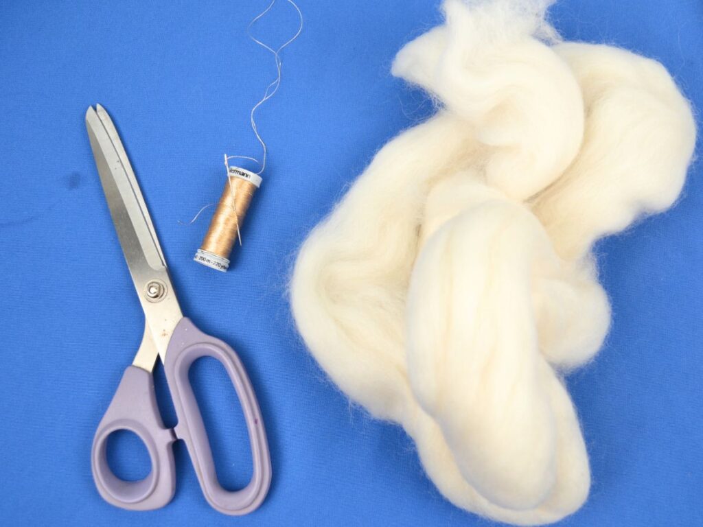 wool, angel materials, scissors, golden thread, and white wool.
Blue background