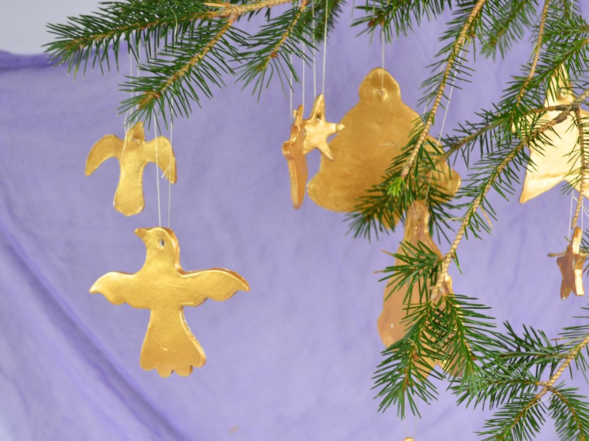 Gold clay decorations hanging from a Christmas tree