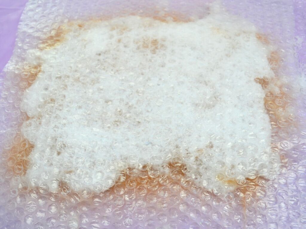 carded wool cover with soap bubbles, and bubble wrap covering it