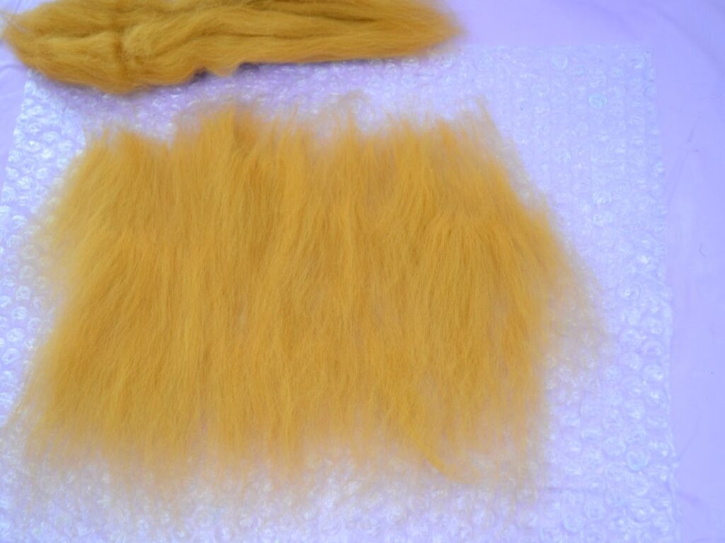 bubble wrap with pieces of carded wool on top