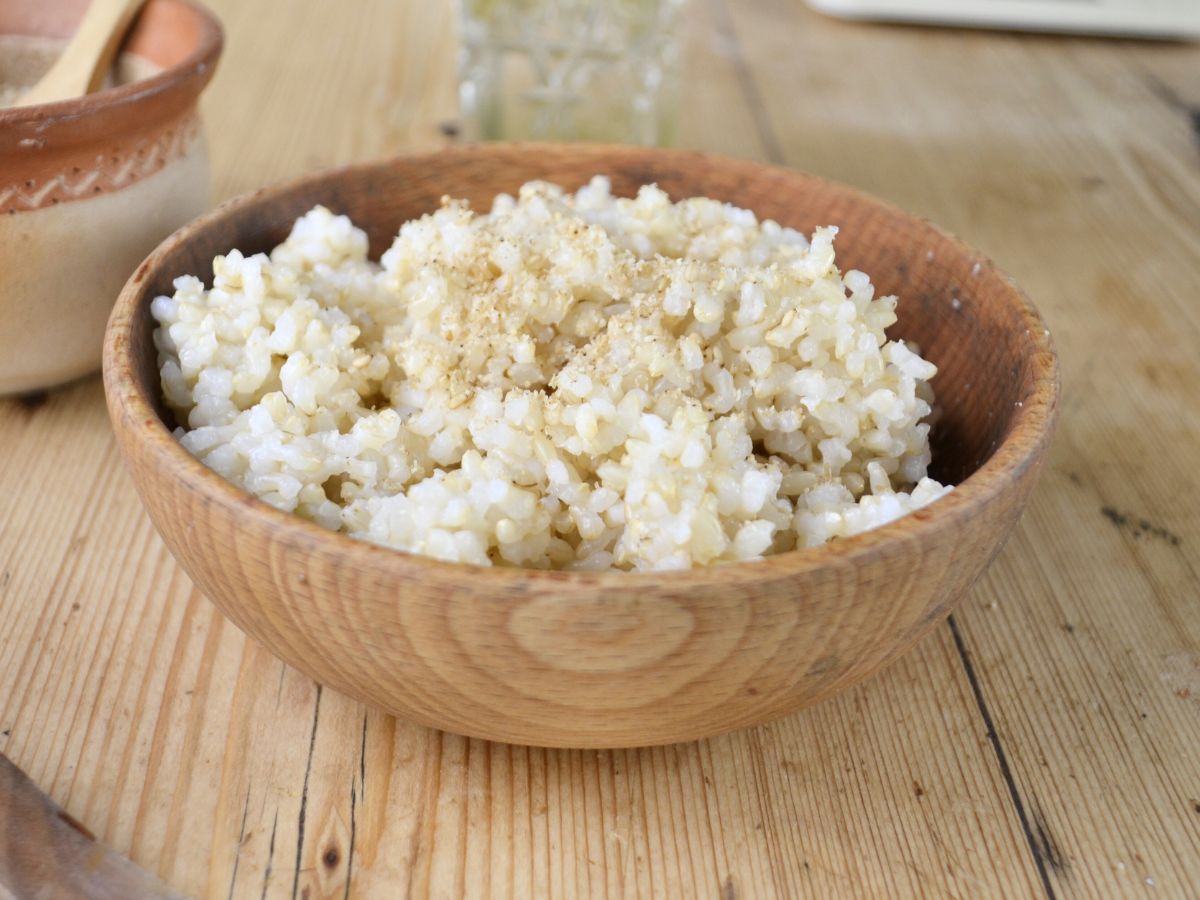 A wooden bowl with short brown rice