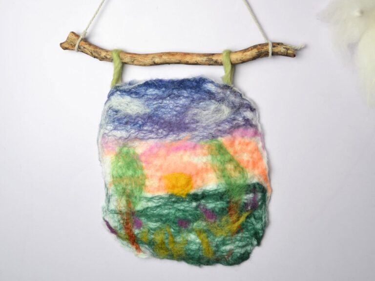 A carded wool picture hanging on the wall.