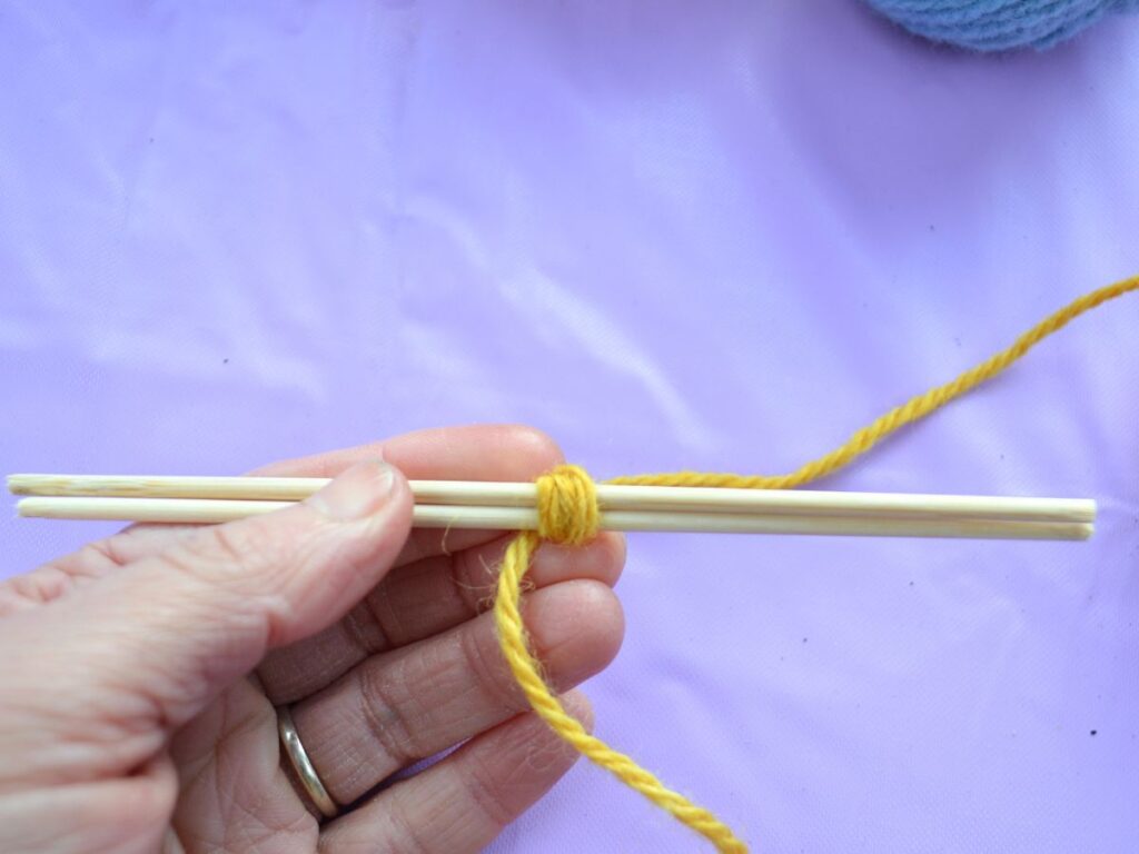 Two sticks with a yarn wrap in the middle.