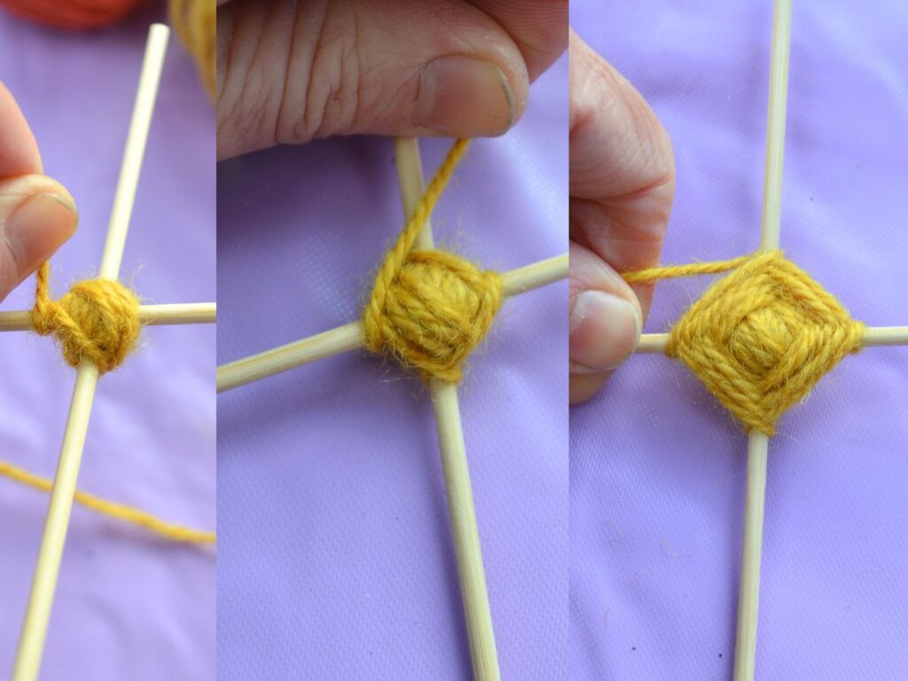 yarn being wrapped around two sticks to make a God's eye.