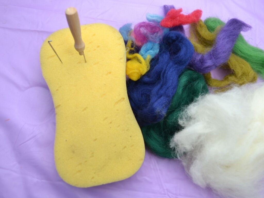 Wool roving, a sponge and felting needles.