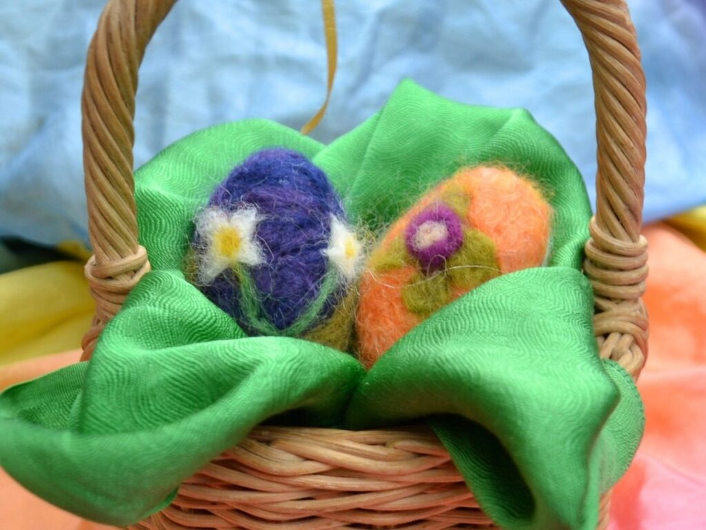 Needle felted easter eggs in a basket.