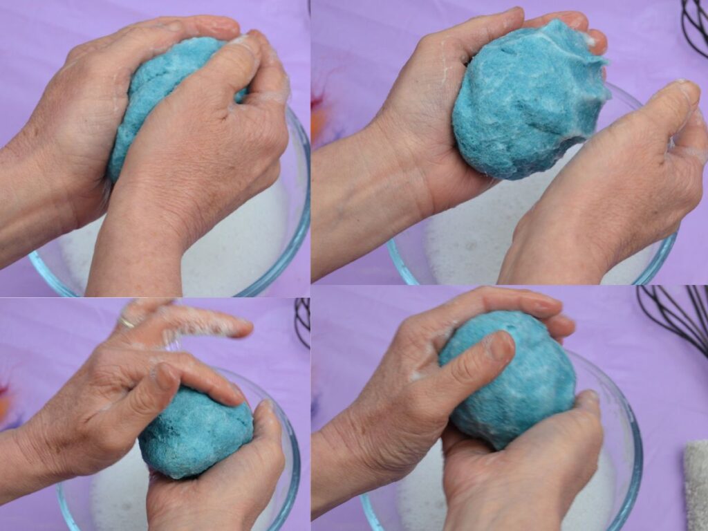 hands felting a wool easter egg.