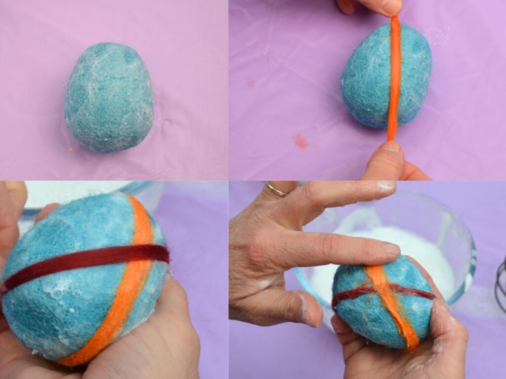 stripes of thin wool roving being attached to a felted easter egg.