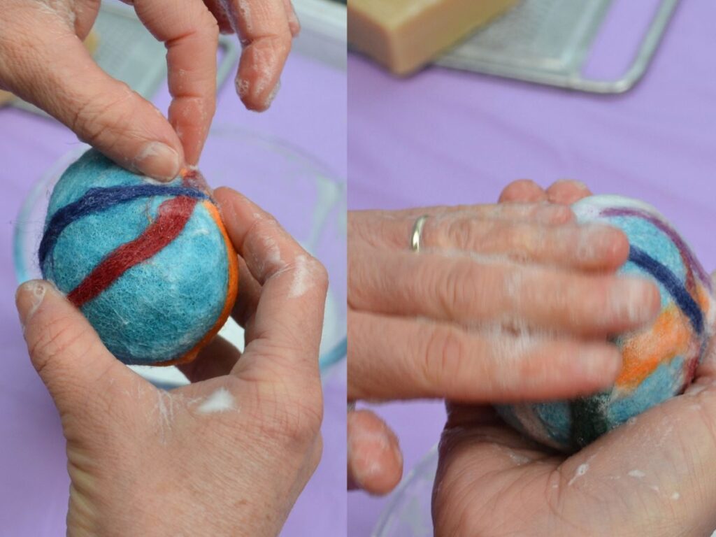 stripes of thin wool roving being attached to a felted easter egg.