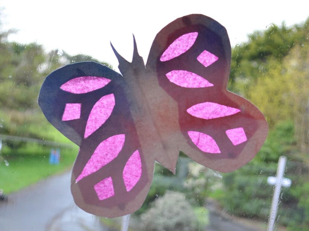 a paper butterfly on the window