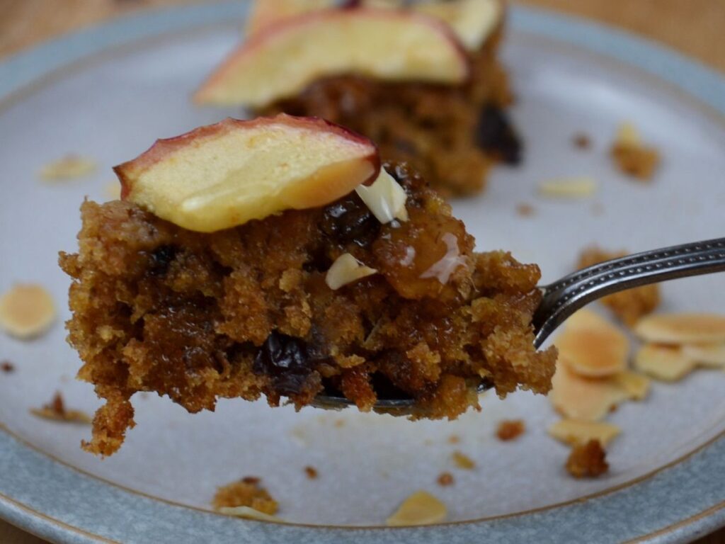 An Apple Cake slice on a spoon.