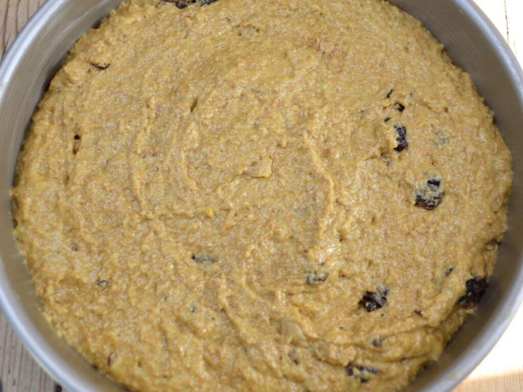 Apple Cake batter in a cake tin.