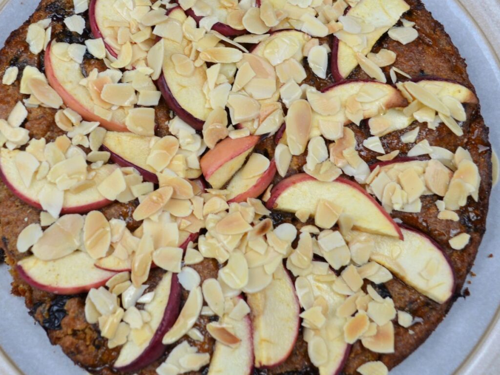 Apple Cake with slice almond and honey on top.