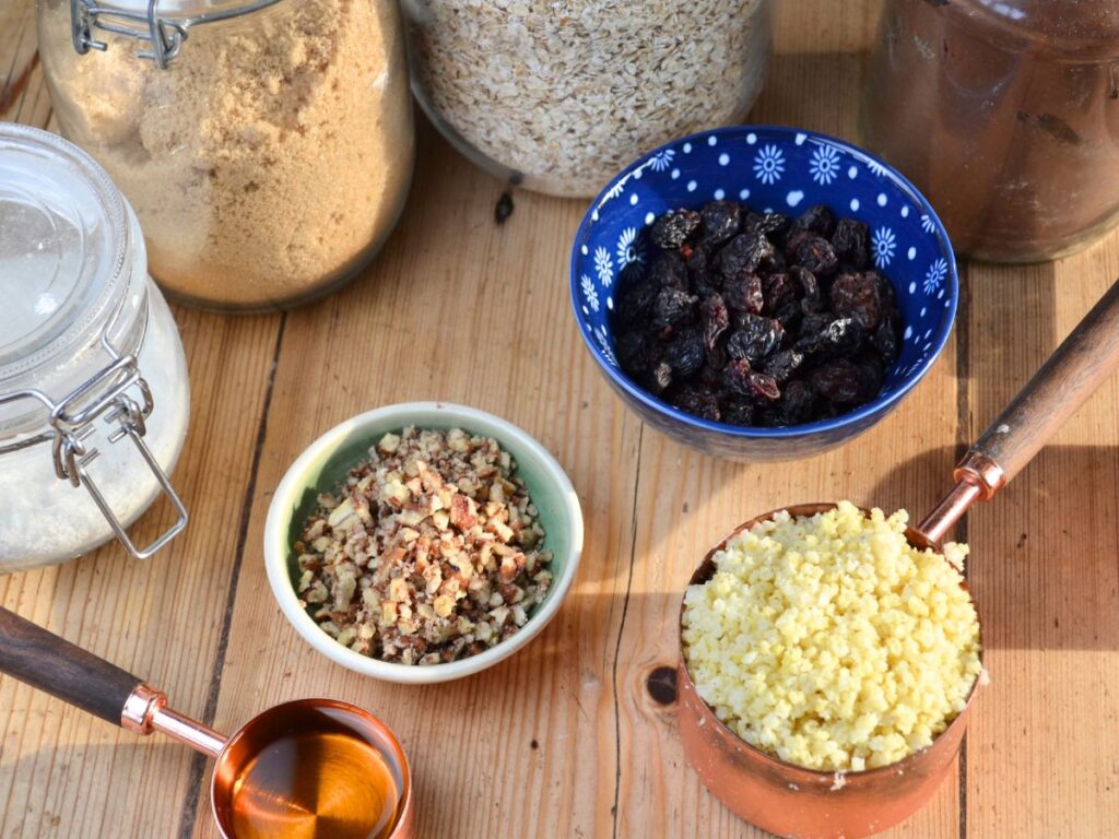 Ingredients for millet chocolate cookies: sugar, raisins, oats, nuts, and millet.