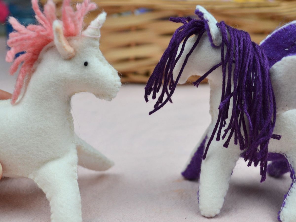 A felt unicorn and a felt pegasus