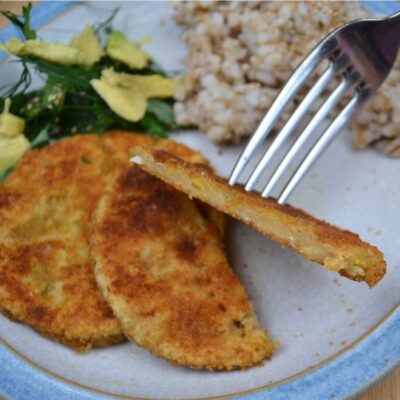 Chickpea Schnitzels in a plate with brown rice and salad.
