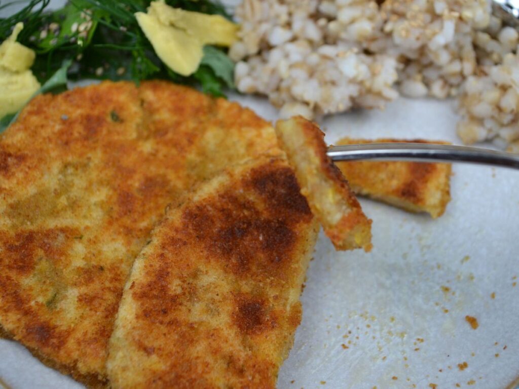 Chickpea Schnitzels in a plate with brown rice and salad.