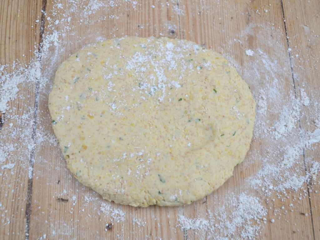 Chickpea Schnitzels dough on a wooden flour surface.