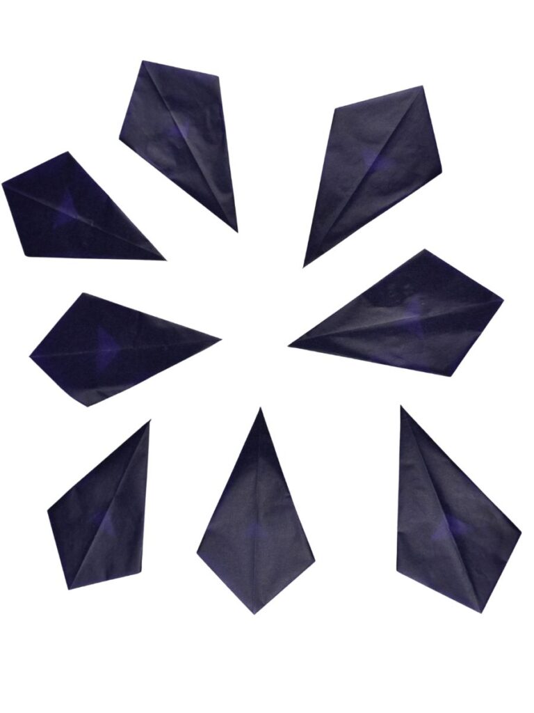 8 Pieces of kite paper folded.
