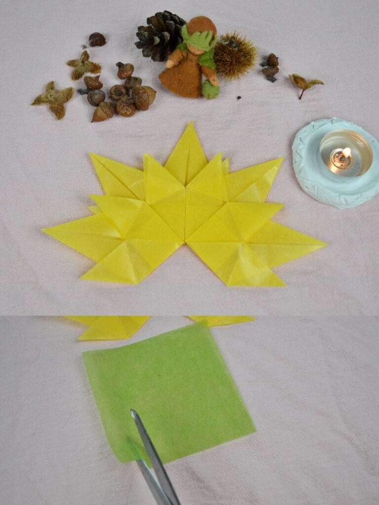 An autumn paper leaf, a tea candle, and nuts and nut shells, and scissors cutting a piece of kite paper.