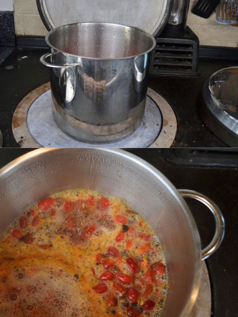 A pot on a stove cooking rosehips.